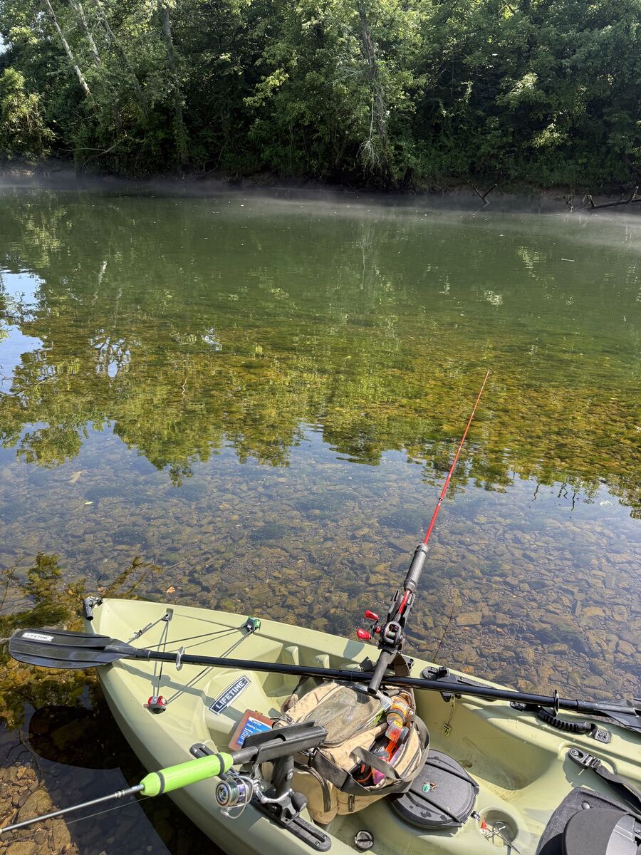 Kayak resting in the clear shallow water of the Obey River